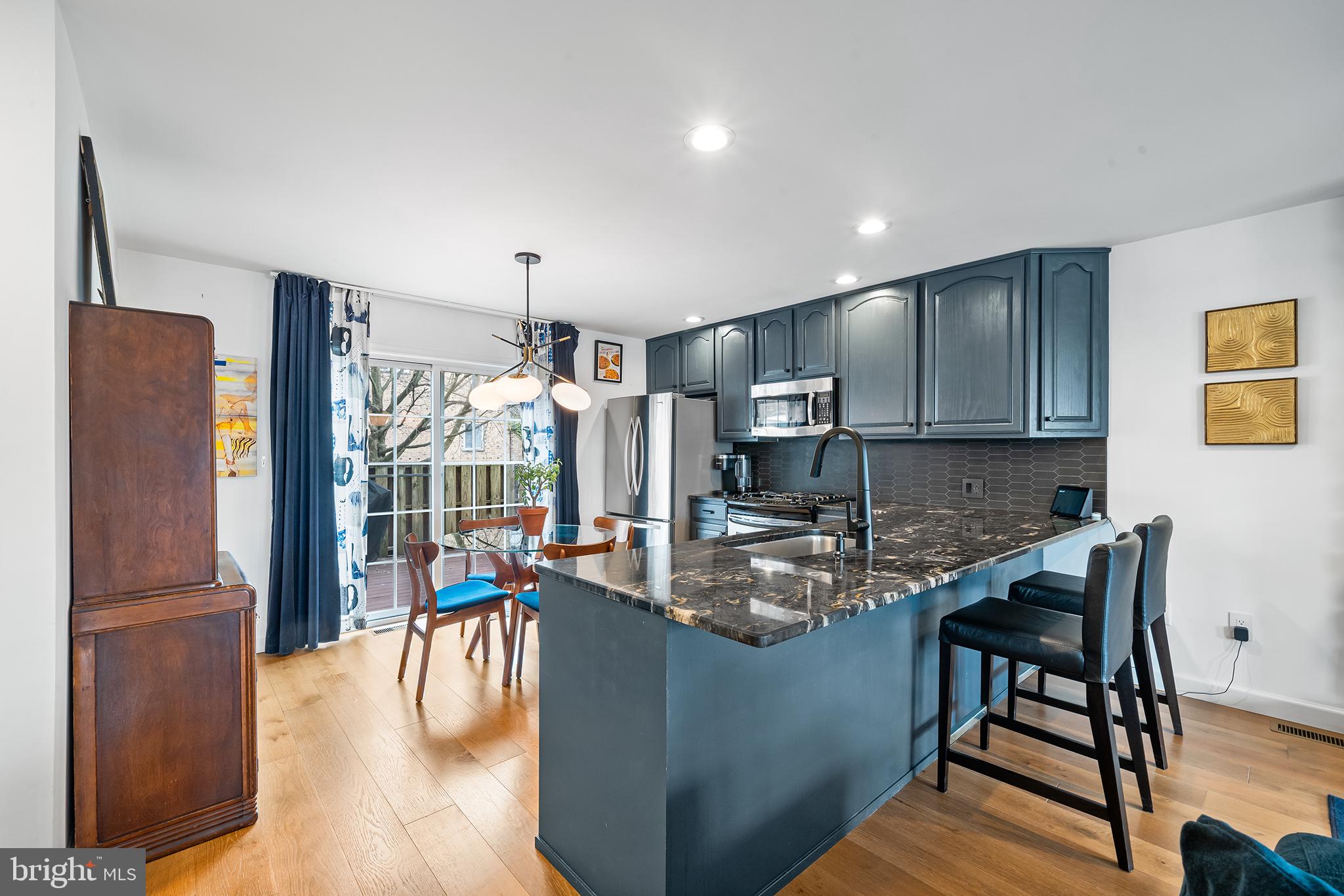 243 Ripka Street Philadelphia, PA 19127 - Photo 6 of 31 a kitchen with kitchen island granite countertop wooden floor and a refrigerator
