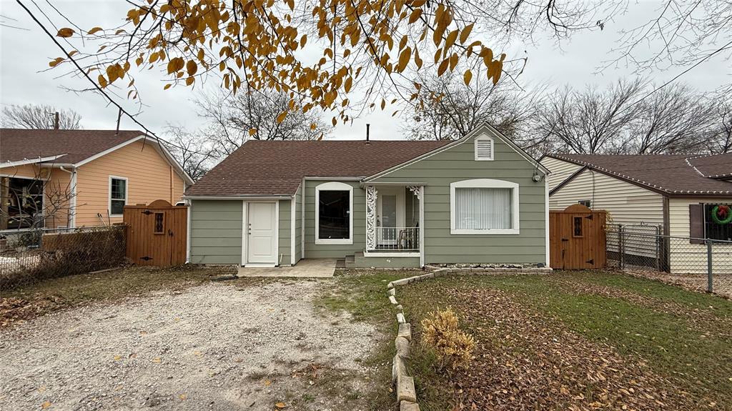2246 Anson Road Dallas, TX 75235 - Photo 1 of 20 Charming single-story residence featuring light green siding, a brown shingle roof, and a gravel driveway