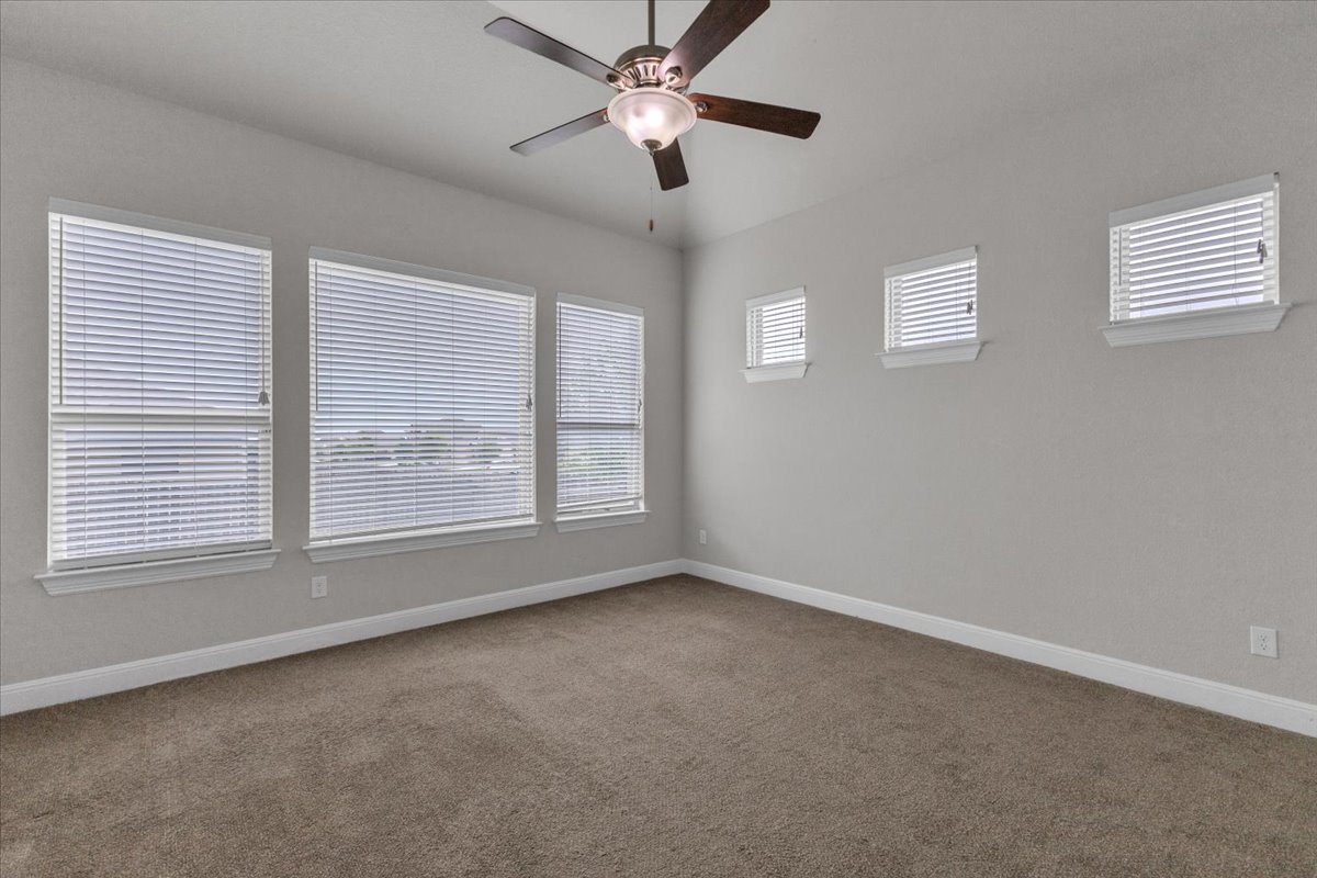 21301 Resource Road Pflugerville, TX 78660 - Photo 13 of 29 Exatra Office room featuring multiple windows with blinds, a ceiling fan with integrated lighting, and neutral wall tones