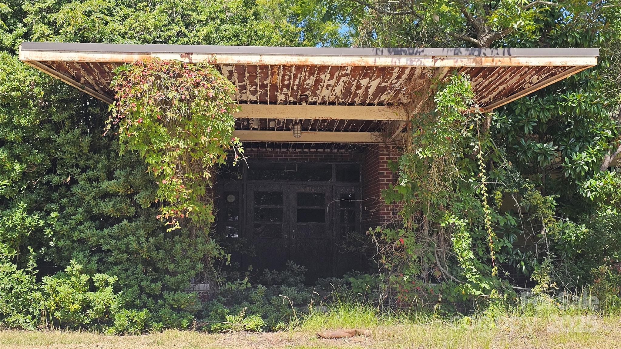 0 Windmill Avenue Dillon, SC 29536 - Photo 8 of 31 a stone house with tall trees