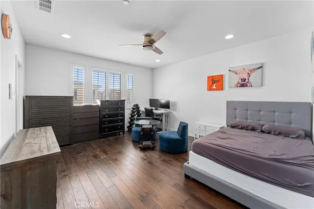 a bedroom with furniture and wooden floor