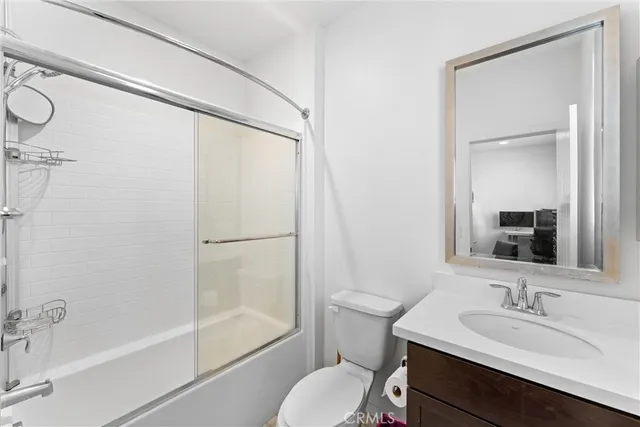 a bathroom with a sink toilet tub and shower