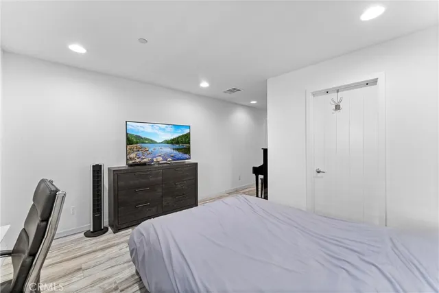 a bedroom with a bed and a dresser