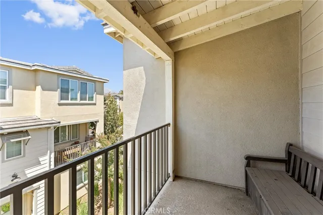 a view of a balcony with wooden floor and fence