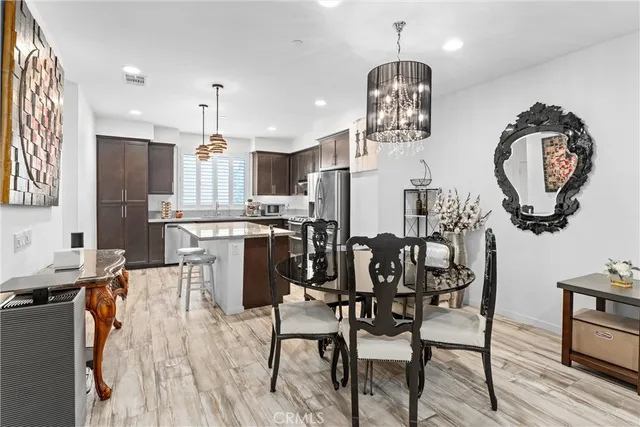 a view of a dining room with furniture and chandelier