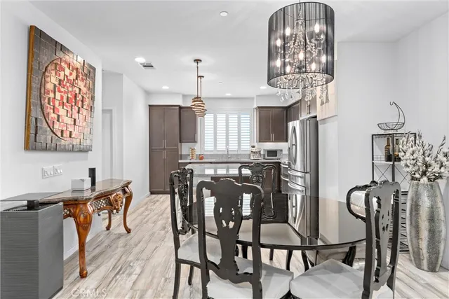a view of a dining room with furniture and chandelier