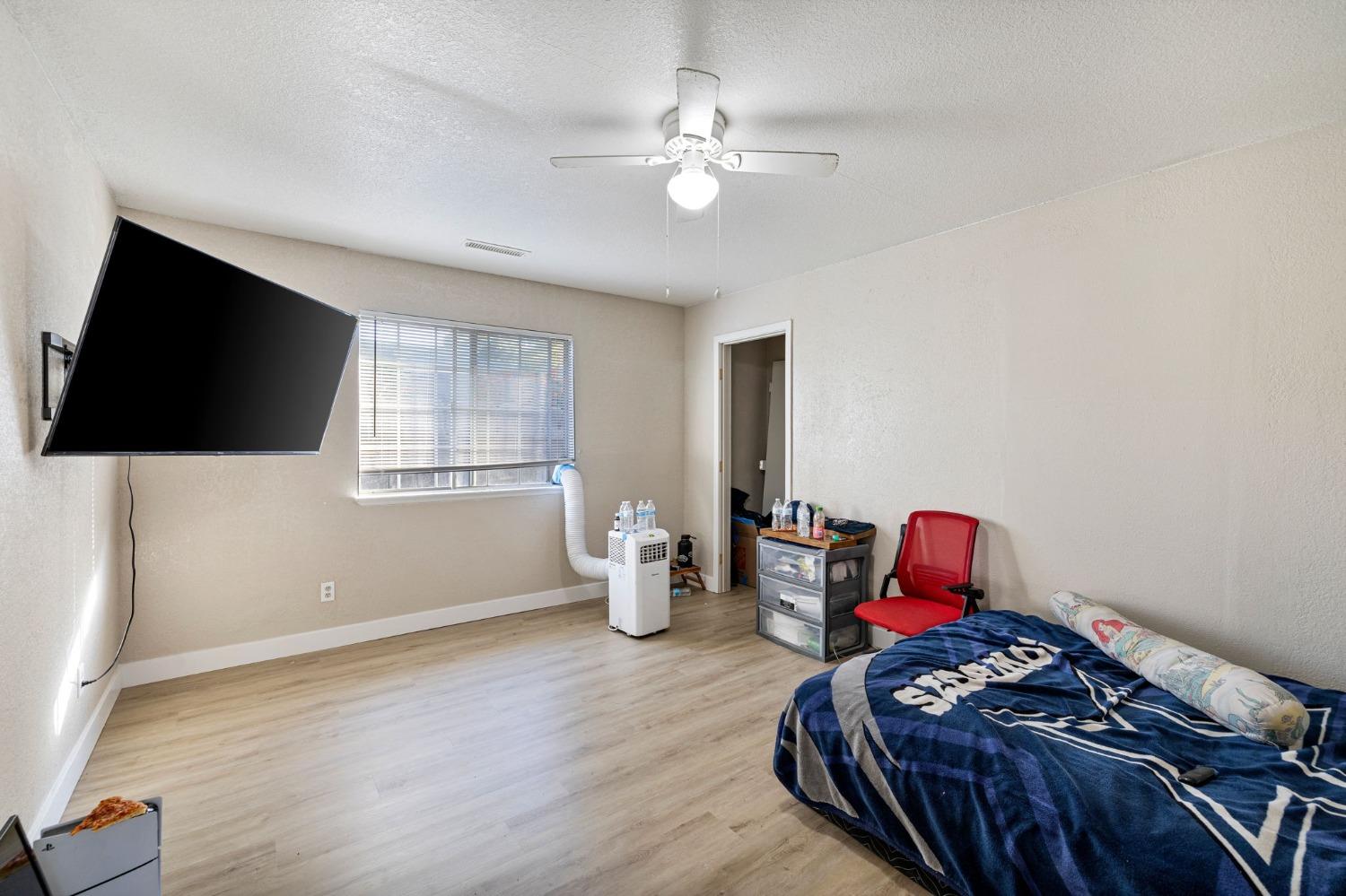 784 Sunnyside Avenue Clovis, CA 93611 - Photo 12 of 28 a bedroom with furniture and a flat screen tv