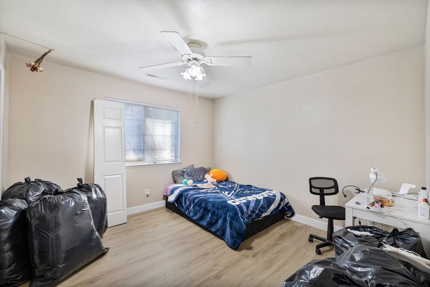 784 Sunnyside Avenue Clovis, CA 93611 - Photo 15 of 28 a bedroom with a bed and window