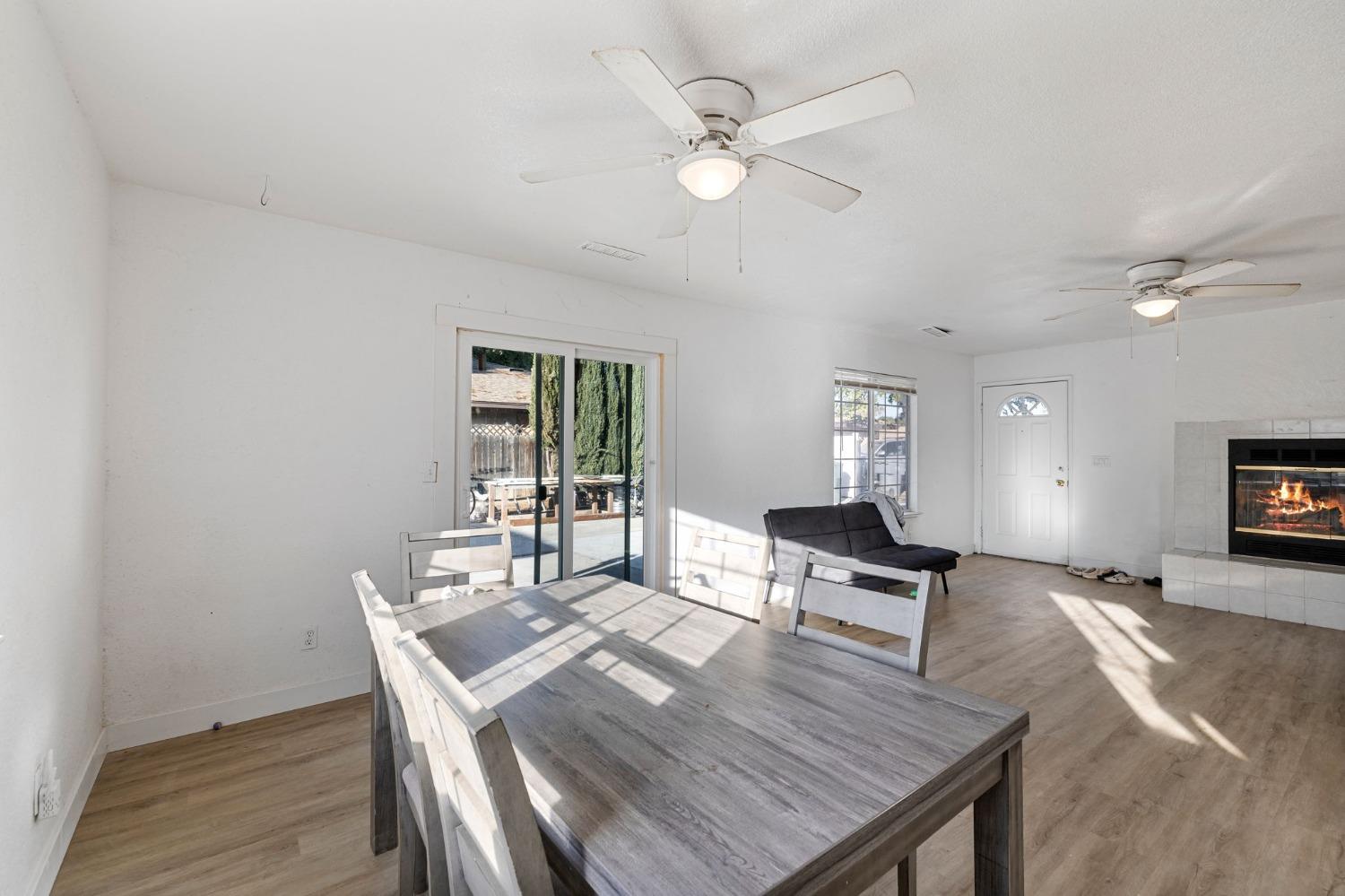 784 Sunnyside Avenue Clovis, CA 93611 - Photo 7 of 28 a living room with furniture a table and wooden floor