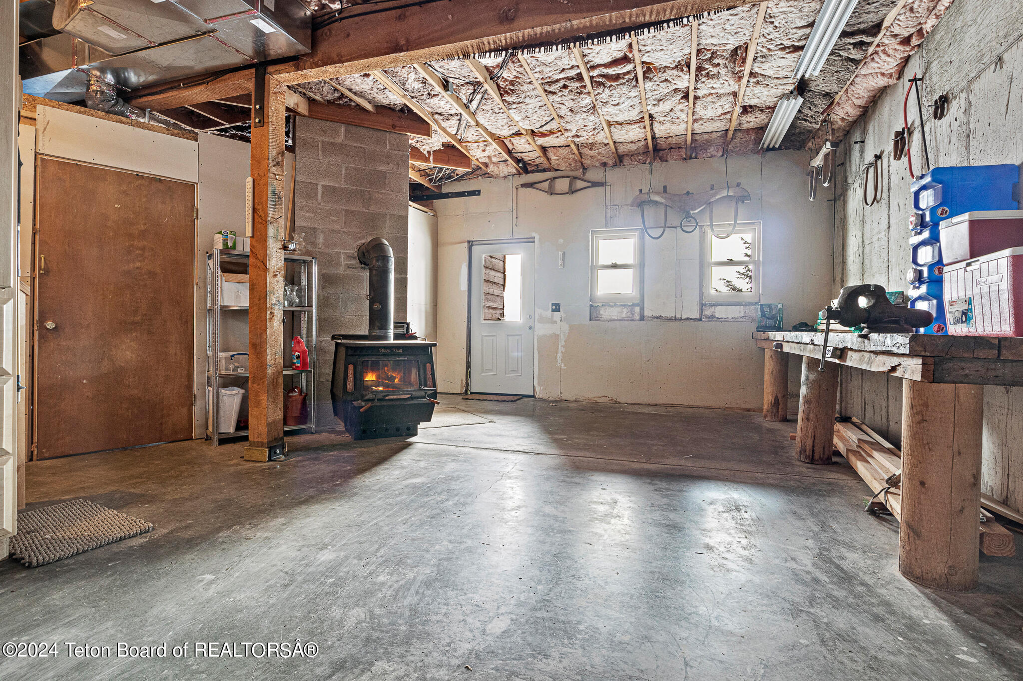 25670 Buffalo Run Moran, WY 83013 - Photo 16 of 28 Garage area w/ woodstove