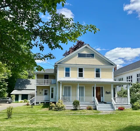 a front view of a house with a garden