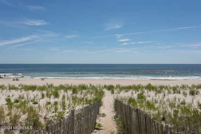 a dining room with furniture a table and kitchen view