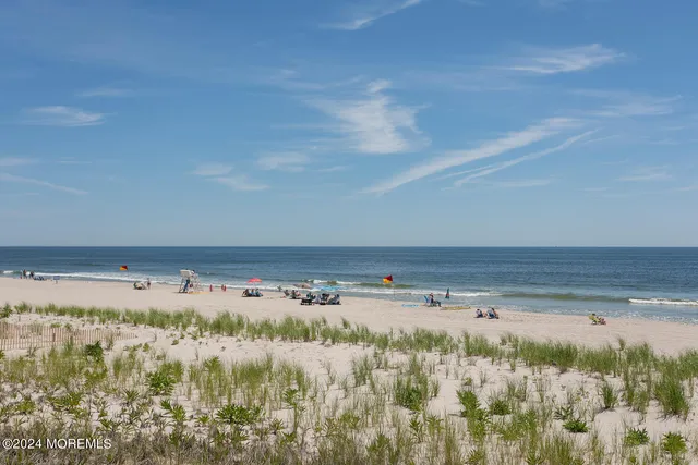 a dining room with furniture and a floor to ceiling window