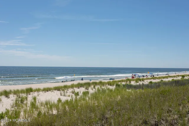 a kitchen with stainless steel appliances kitchen island granite countertop a dining table chairs and granite counter tops