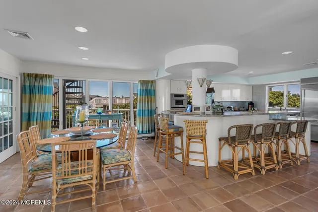 a bedroom with furniture and a large window