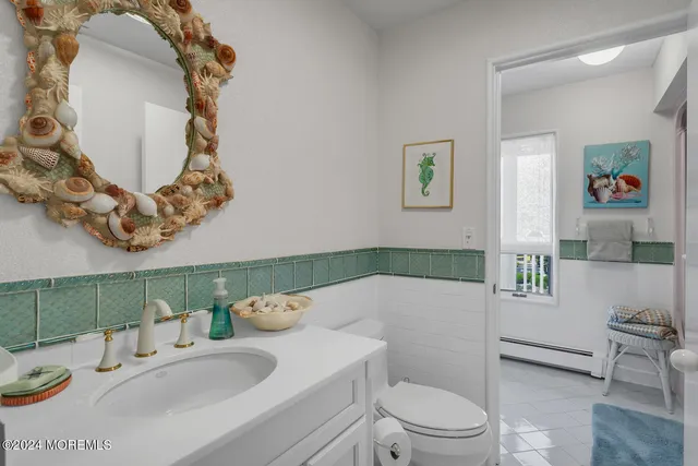 a bedroom with a bed a flat screen tv and a large window