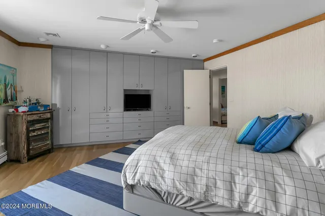 a living room with furniture and a ceiling fan