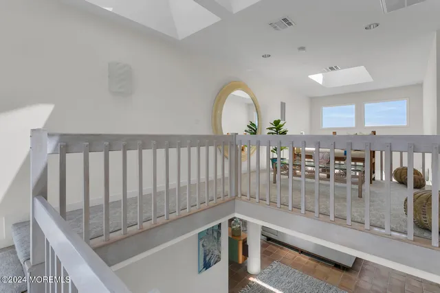 a living room with furniture a flat screen tv and a large window