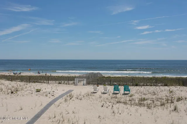 a spacious bedroom with a bed and ceiling fan