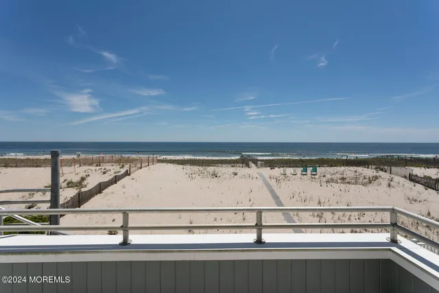 a view of a house with a yard and potted plants