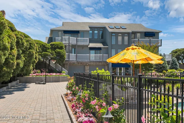 a view of a lake with couches chairs and an umbrella