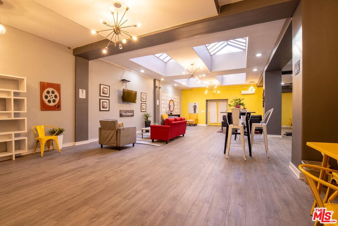 729 South Union Avenue, Unit 207 Los Angeles, CA 90017 - Photo 16 of 19 a living room with furniture and a wooden floor