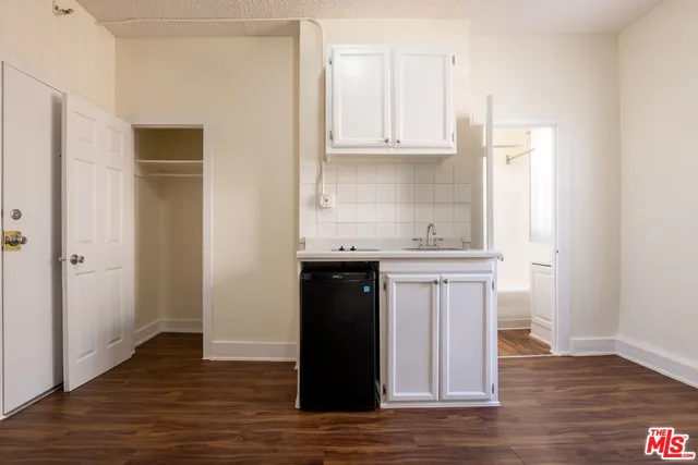 a kitchen with stainless steel appliances granite countertop a refrigerator and cabinets
