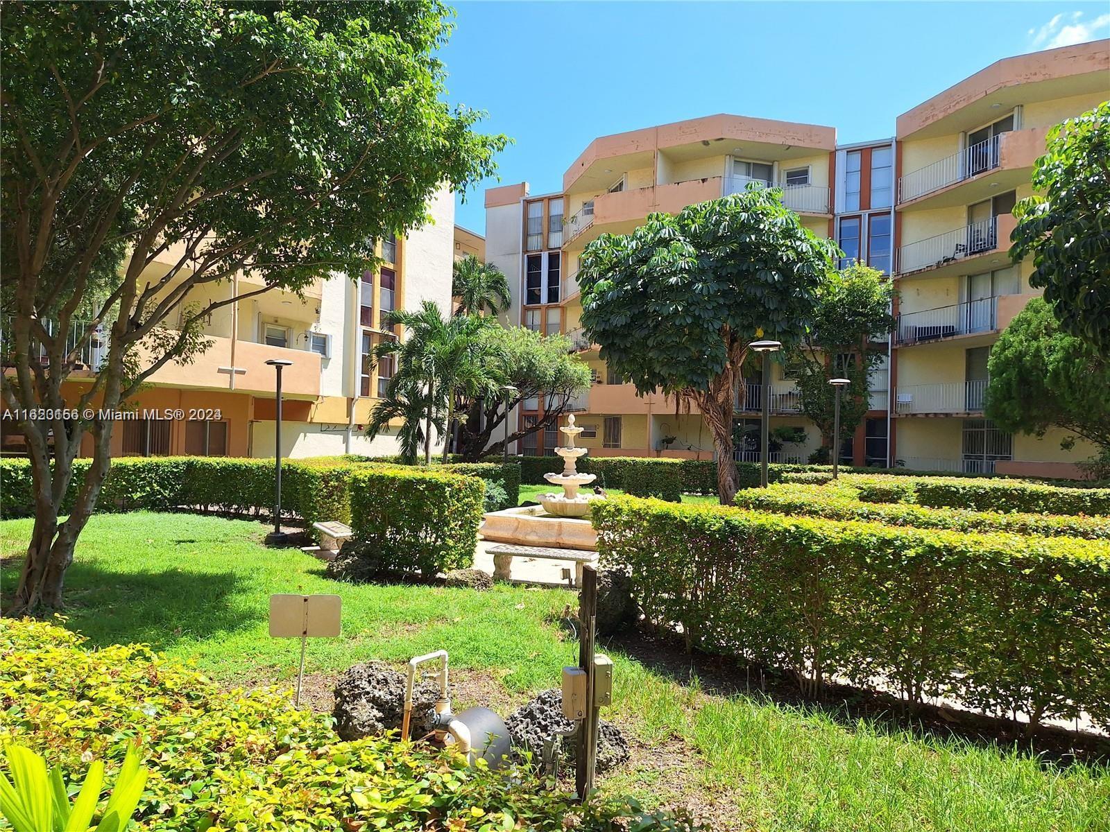 1750 West 46th Street, Unit 433 Hialeah, FL 33012 - Photo 12 of 14 a front view of a house with a yard