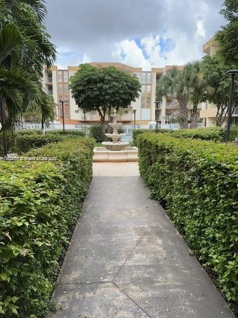 1750 West 46th Street, Unit 433 Hialeah, FL 33012 - Photo 13 of 14 a view of a garden with a bench