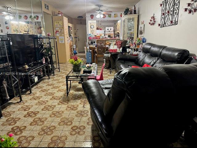 1750 West 46th Street, Unit 433 Hialeah, FL 33012 - Photo 2 of 14 a living room with furniture a flat screen tv and a dining table