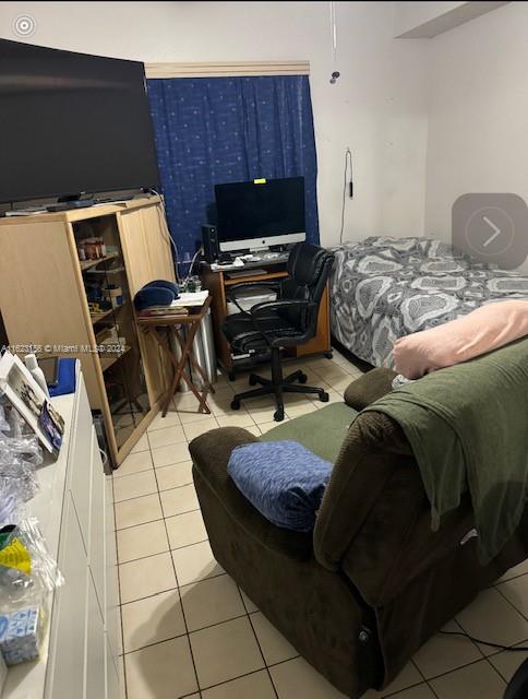 1750 West 46th Street, Unit 433 Hialeah, FL 33012 - Photo 5 of 14 a bedroom with a bed and musical instruments