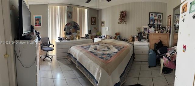 1750 West 46th Street, Unit 433 Hialeah, FL 33012 - Photo 6 of 14 a living room with furniture a flat screen tv and a table