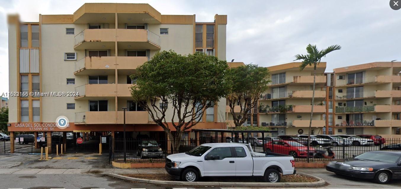 1750 West 46th Street, Unit 433 Hialeah, FL 33012 - Photo 9 of 14 a car parked in front of a building