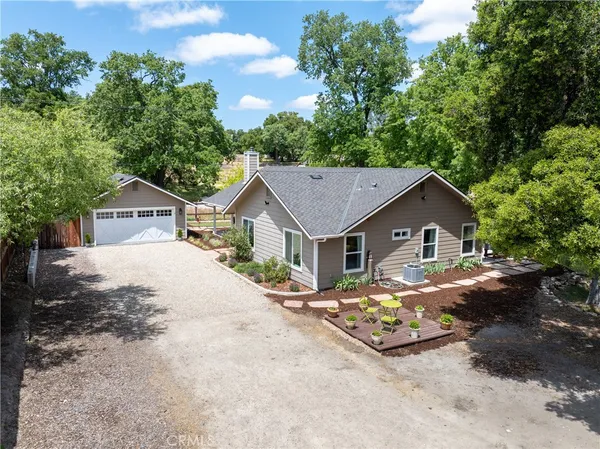 a dirt road with a house in the background