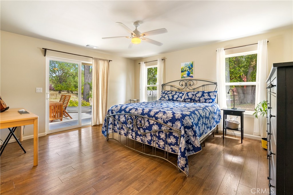 10825 Colorado Road Atascadero, CA 93422 - Photo 15 of 35 a bedroom with a large bed and a chandelier