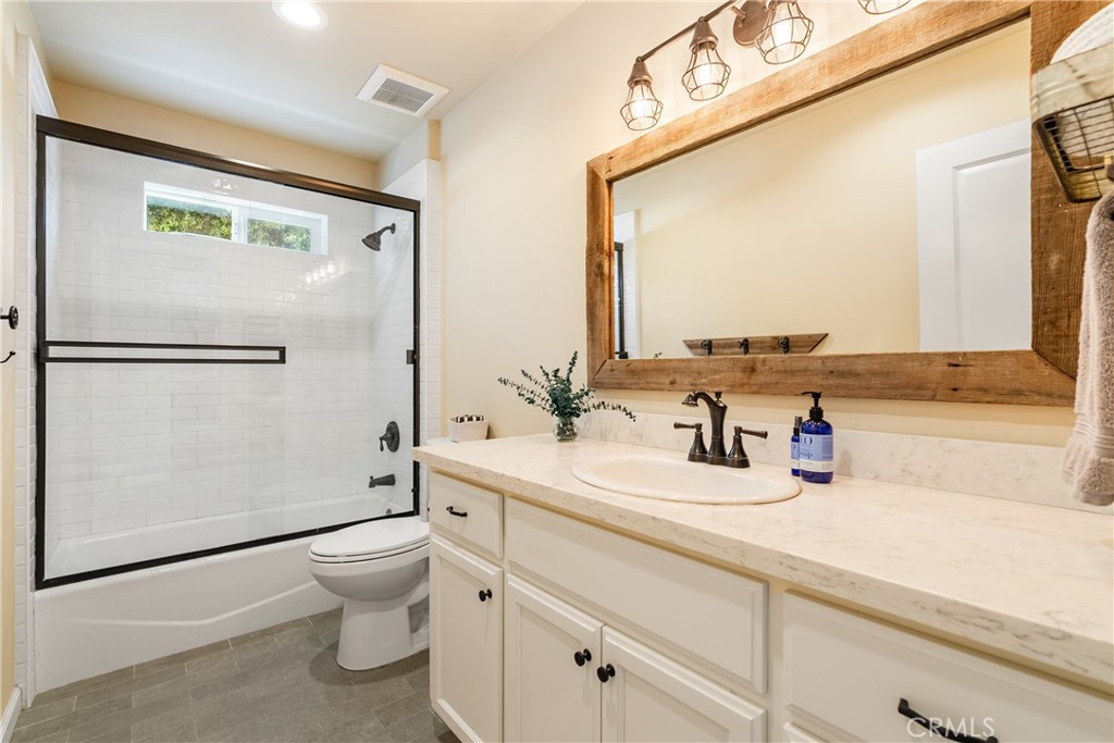 10825 Colorado Road Atascadero, CA 93422 - Photo 22 of 35 a bathroom with a granite countertop sink mirror vanity and toilet