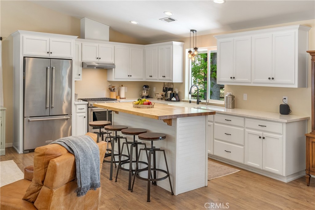 10825 Colorado Road Atascadero, CA 93422 - Photo 10 of 35 a kitchen with stainless steel appliances white cabinets and wooden floors