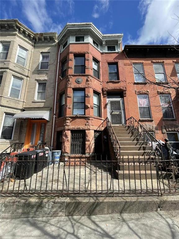 a front view of a residential apartment building with a yard