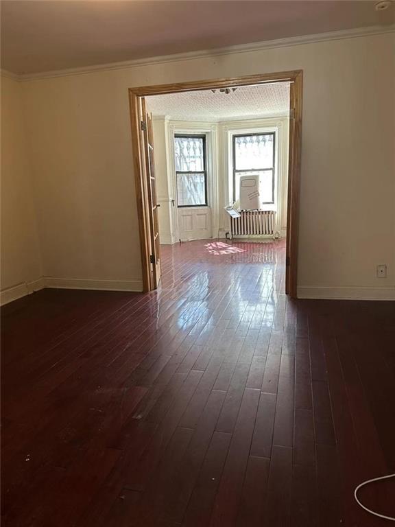449 54th Street Brooklyn, NY 11220 - Photo 3 of 4 a view of wooden floor and windows in a room