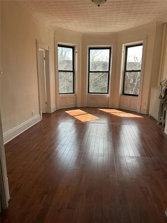 449 54th Street Brooklyn, NY 11220 - Photo 4 of 4 an empty room with wooden floor and windows