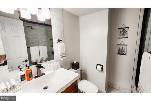 a bathroom with a sink toilet and mirror