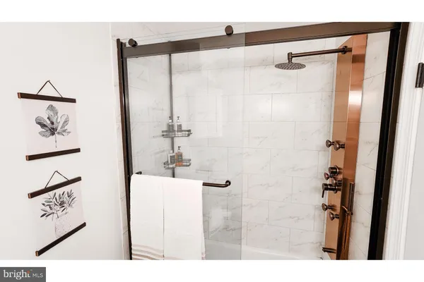 a bathroom with a shower and a mirror