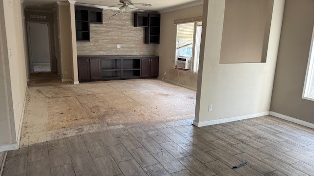 71 Trail Ridge Road Huntsville, TX 77320 - Photo 12 of 16 an empty room with wooden floor and fireplace