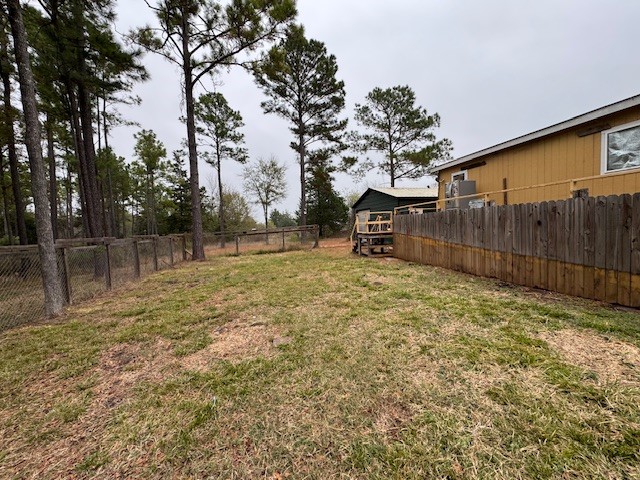 71 Trail Ridge Road Huntsville, TX 77320 - Photo 3 of 16 a backyard of a house with a tree