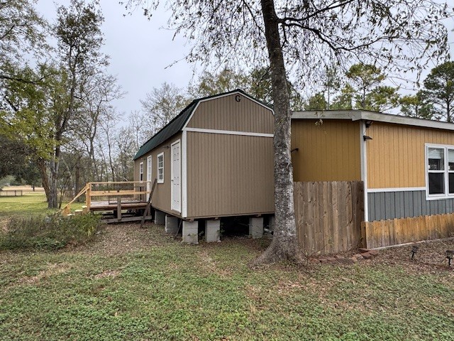 71 Trail Ridge Road Huntsville, TX 77320 - Photo 9 of 16 a backyard of a house with barbeque oven and swing