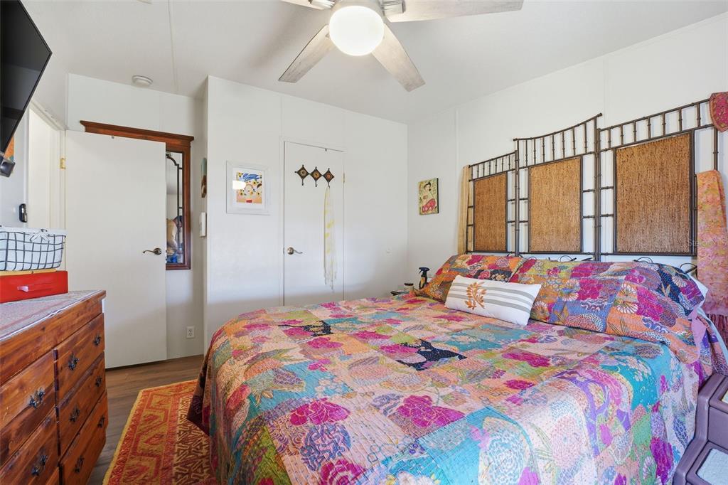 11269 Southwest Welch Avenue Arcadia, FL 34269 - Photo 19 of 41 a bedroom with a bed and a chandelier