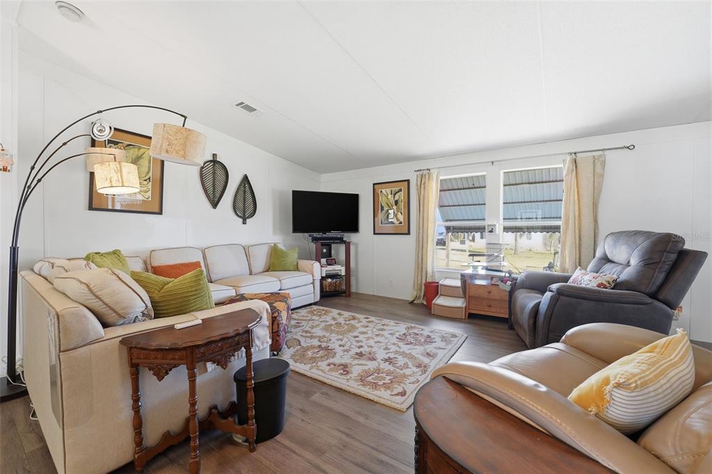 11269 Southwest Welch Avenue Arcadia, FL 34269 - Photo 7 of 41 a living room with furniture and a flat screen tv