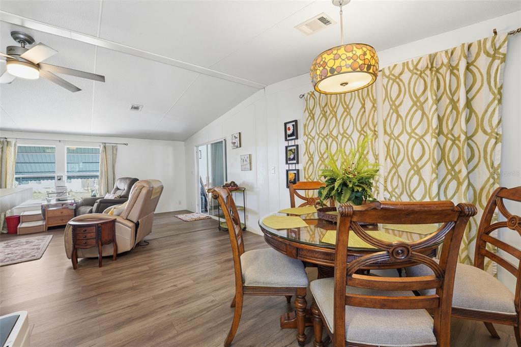 11269 Southwest Welch Avenue Arcadia, FL 34269 - Photo 9 of 41 a view of a dining room with furniture and wooden floor