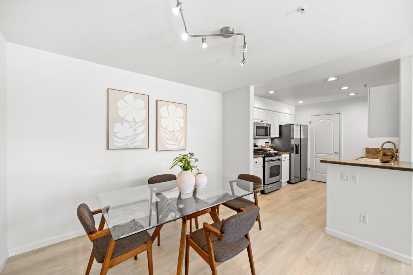 986 Alpine Terrace, Unit 4 Sunnyvale, CA 94086 - Photo 14 of 59 a kitchen with stainless steel appliances kitchen island granite countertop a dining table chairs and a refrigerator