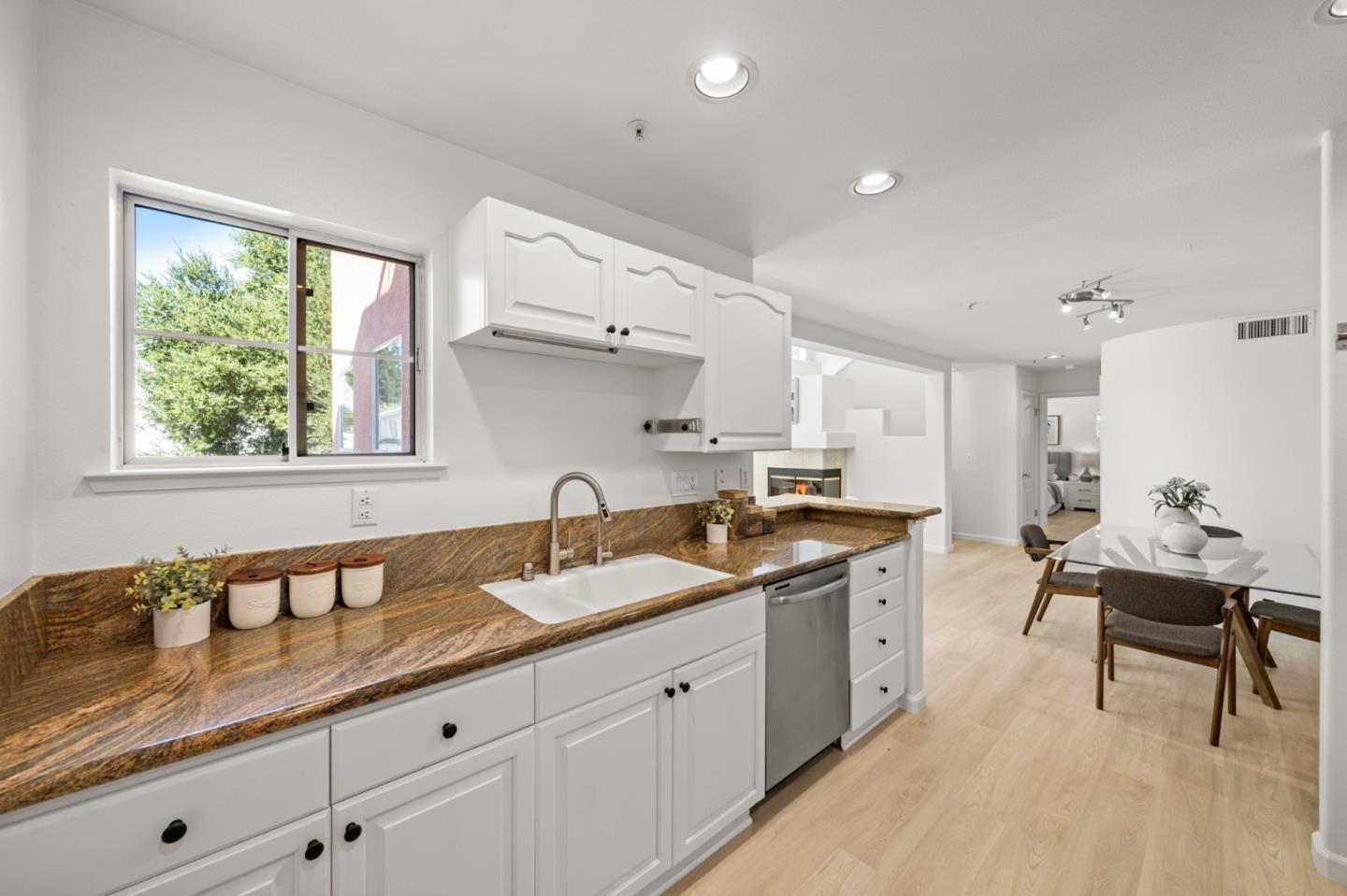 986 Alpine Terrace, Unit 4 Sunnyvale, CA 94086 - Photo 17 of 59 a kitchen with granite countertop a sink and white cabinets